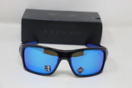 A boxed as new pair of Oakley Turbine Sunglasses in Black Ink with Prizm Sapphire Lens (REF: OO9263,