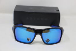 A boxed as new pair of Oakley Turbine Sunglasses in Black Ink with Prizm Sapphire Lens (REF: OO9263,