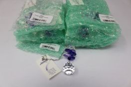 Twelve as new Woodstock Chimes Crystal Sunrise Cascade Sun-Catchers in Purple (EAN: 028375270118).