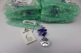 Twelve as new Woodstock Chimes Crystal Sunrise Cascade Sun-Catchers in Purple (EAN: 028375270118).