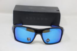A boxed as new pair of Oakley Turbine Sunglasses in Black Ink with Prizm Sapphire Lens (REF: OO9263,