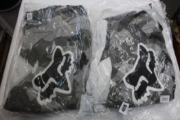 Two as new Fox Racing 180 BKNR Pants in Black Camo (Sizes 1x Youth 28, 1x 38).