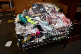 A basket full of miscellaneous as new clothing and related.