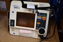 A pre-owned Medtronic Lifepak 12 ECG machine (Batteries not included) (Untested, viewing advised).