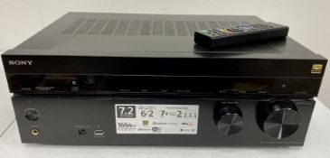 A pre-owned Sony STR-DN1080 7.2-Channel UHD AV Receiver with remote control.