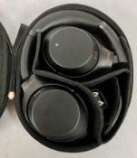 A pre-owned pair of Sony WH-1000XM3 Noise Cancelling Wireless Headphones with case, airplane adaptor