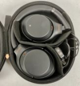 A pre-owned pair of Sony WH-1000XM3 Noise Cancelling Wireless Headphones with case, airplane adaptor