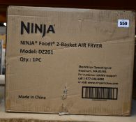 A pre-owned Ninja Foodi 2-Basket Air Fryer.