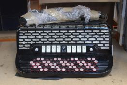 A pre-owned Crucianelli Button Accordion (Damaged, needs repair).