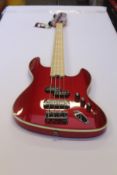 An as new Tribe SF 4 Red Passion Maple Neck Bass Guitar with gig bag.