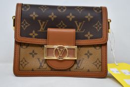 A Louis Vuitton Dauphine Mini Leather Bag in Monogram Reverse Brown (M44580).