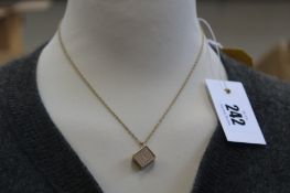 A sweet 10-note encased in 9ct gold charm on a fine French gold chain, total weight 4.89g