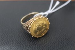 An 1893 half sovereign, set in an elaborate Victorian 9ct setting, total weight 9.39g.