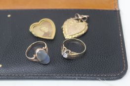 Two 9ct gold rings and a broken gold locket, total weight 0.35g.