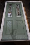 A composite door in green, 88cm x 20cm x 7cm.