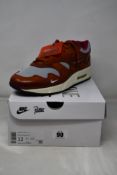 A pair of boxed as new Nike Air Max 1 Patta 'Waves' in Dark Russet (UK 11).