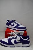 A pair of as new Nike Dunk Low Retro with authenticity tag (UK 9).
