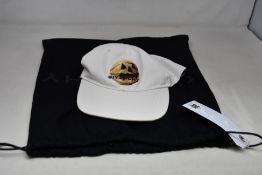 A men's Givenchy white baseball cap with decal to front of hat and dust bag (One size).