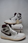 A pair of boxed as new Air Jordan 1 Retro High OG x A Ma Maniere - Sail/Burgundy Crush (UK 9).