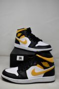 A pair of as new Nike Air Jordan 1 Mid White/Pollen-Black (Size UK 8.5).