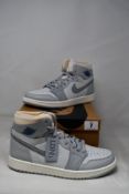 A pair of boxed as new Nike Air Jordan 1 High Zoom Air CMFT London in Photon Dust/Light Smoke