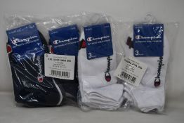 Twenty eight packs of three Champion sports socks in various sizes and colours.