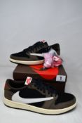 A pair of as new Nike x Travis Scott Jordan 1 Retro Low OG SP in Black/Sail-Dark Mocha (UK 8.5).