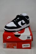 A pair of women's as new Nike Dunk Low Trainers in White/Black-White (Size UK 3).