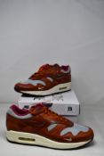 A pair of boxed as new Nike Air Max 1 Patta 'Waves' in dark russet (UK 10).