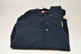 An as new Tommy Hilfiger Varsity Bomber Jacket - Desert Sky (S).