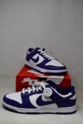 A pair of as new Nike Dunk Low Retro with authenticity tag (UK 9).