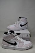 A pair of as new Nike Air Jordan 1 mid (UK 5.5).