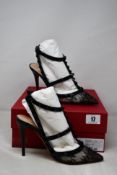 A pair of women's boxed as new Valentino Garavani High Heel Rockstud Pumps in black (UK 4).