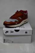 A pair of boxed as new Nike Air Max 1 Patta 'Waves' in Dark Russet (UK 10.5).