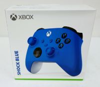 A boxed as new Xbox Wireless Controller in Shock Blue (Box sealed, some damage to box) (EAN: 8898426