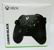 A boxed as new Xbox Wireless Controller in Carbon Black (Box sealed, some damage to box) (EAN: 88984