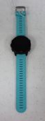 A pre-owned Garmin Forerunner 245 Music GPS Watch in Black with Blue Band (Grade B).