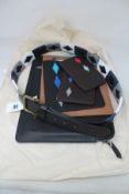 As new Pampeano Italy leather accessories: One belt and five tech sleeves.