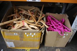 A large box of assorted branded clothes hangers and a box of pink plastic clothes hangers.