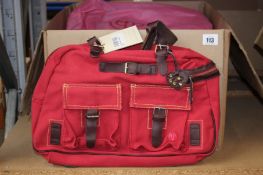 Seven Petit Planet urban bags in red.