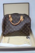An as new boxed Louis Vuitton monogram speedy 30 handbag with dust bag and padlock and keys (