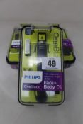 Three boxed as new Philips One Blade face/body hair trimmer shavers.