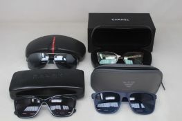 Three pairs of men's branded sunglasses to include Ralph Lauren, Prada, Armani and one pair of