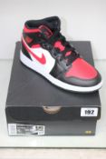 A pair of boxed as new Nike Air Jordan Mid (GS) - Black/Fire Red White (UK 3.5).