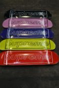 Five as new Supreme Kaws skateboard decks in various colours.
