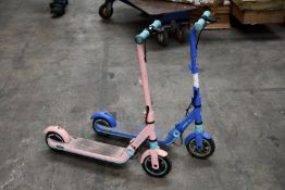 Two pre-owned Segway Ninebot Kids Electric Scooters, one in Pink and one in Blue
