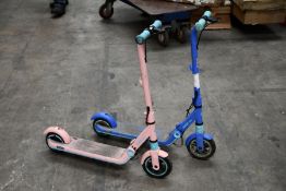 Two pre-owned Segway Ninebot Kids Electric Scooters, one in Pink and one in Blue