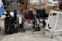 Four assorted folding wheel chairs and one Zimmer frame