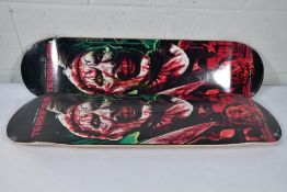 Two as new skateboard decks with a Damen Leone film Terrifier motif to deck