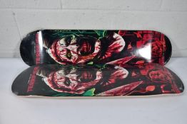 Two as new skateboard decks with a Damen Leone film Terrifier motif to deck